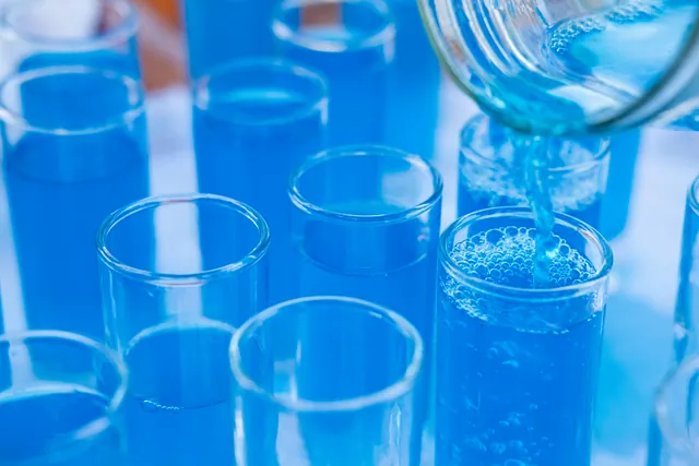 Water being poured into test tubes.